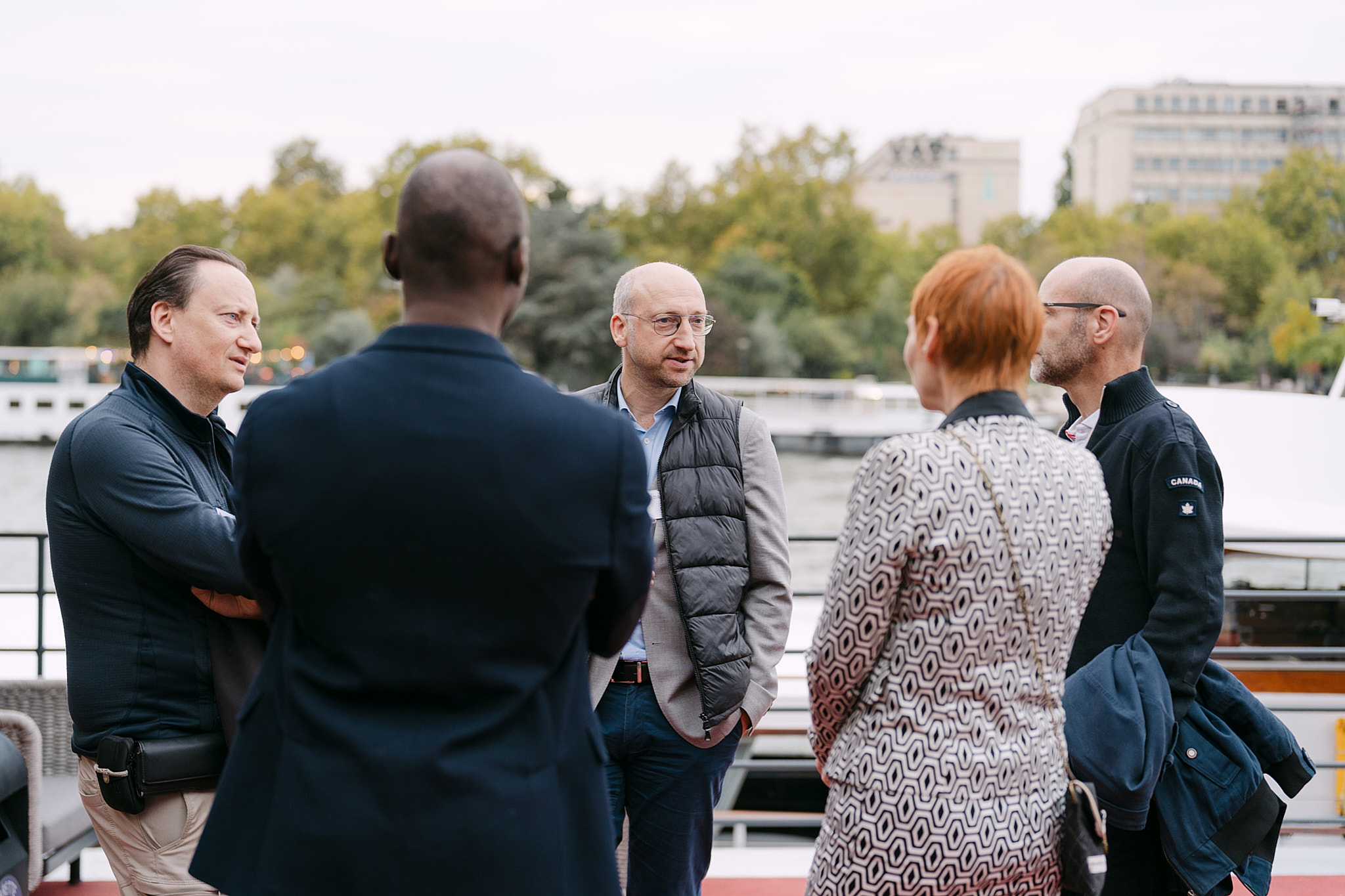 Business leaders networking on a private boat cruising the Seine during the Diligent corporate event in Paris, captured for event film and editorial stills